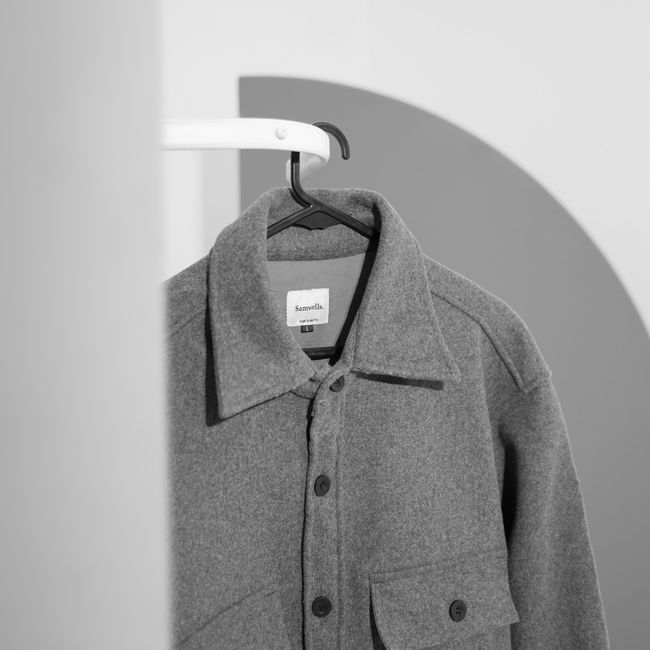 Grey men's button-up shirt on a hanger